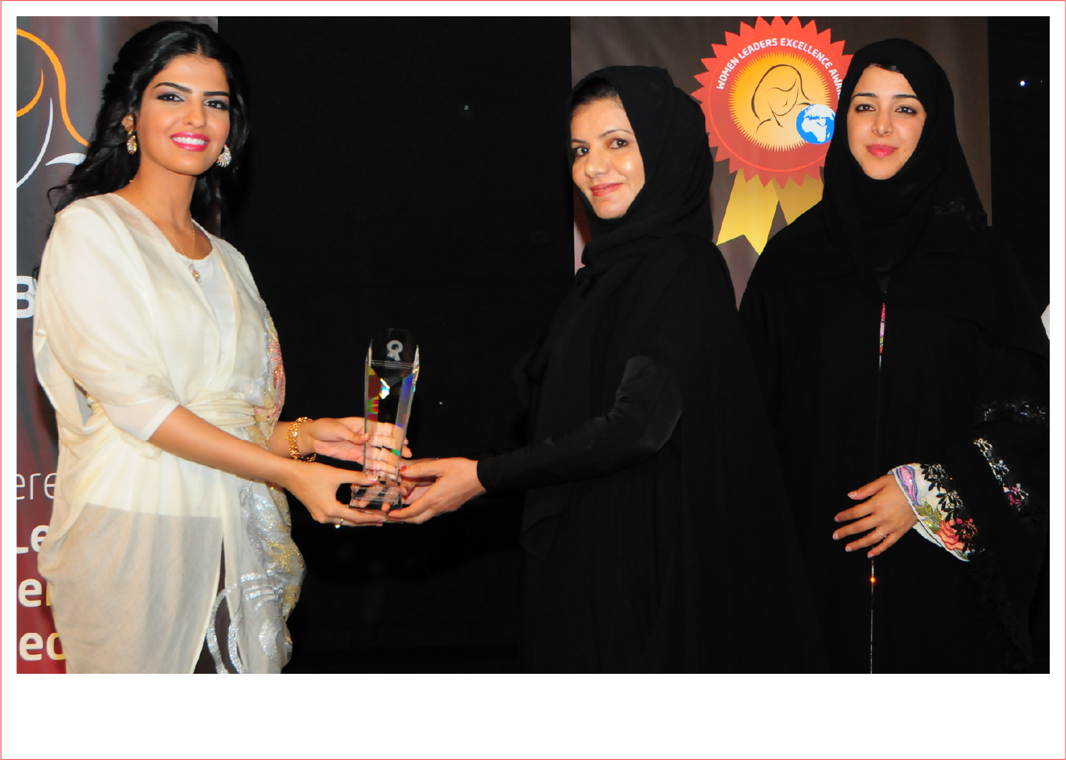 Honouree receiving a crystal award from a distinguished guest